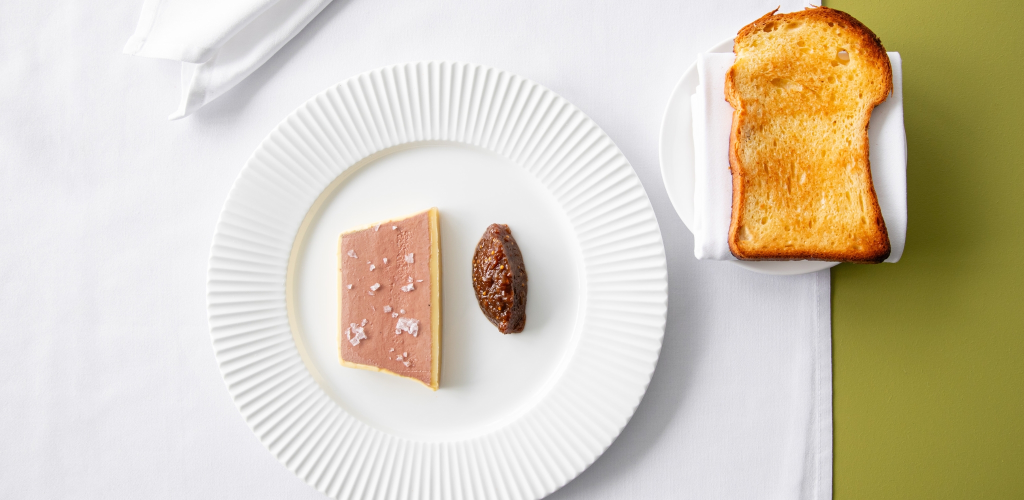 Image of Jacksons on George's chicken liver parfait with bitter orange puree on a white plate with toasted brioche slice on a side plate with white napkin.
