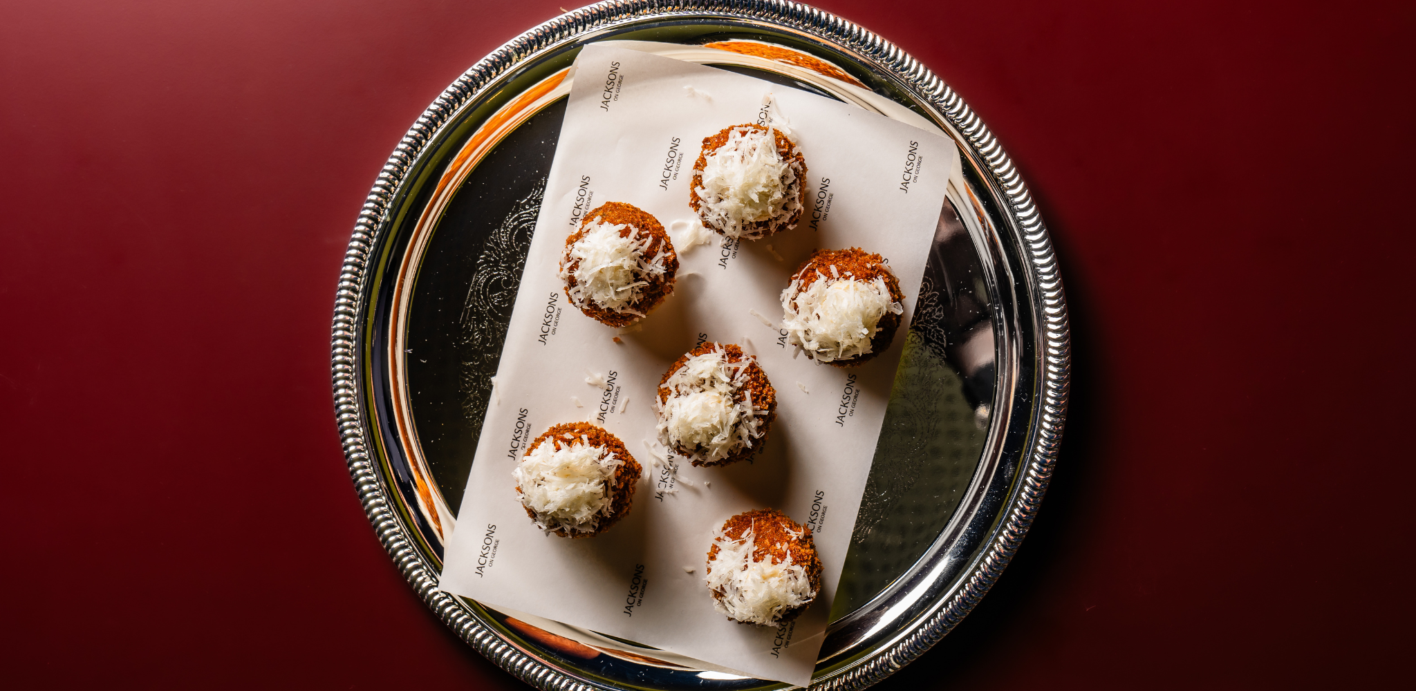 Image of mushroom arancini, parmesan and truffle aioli on a silver platter served at events at Jacksons on George.