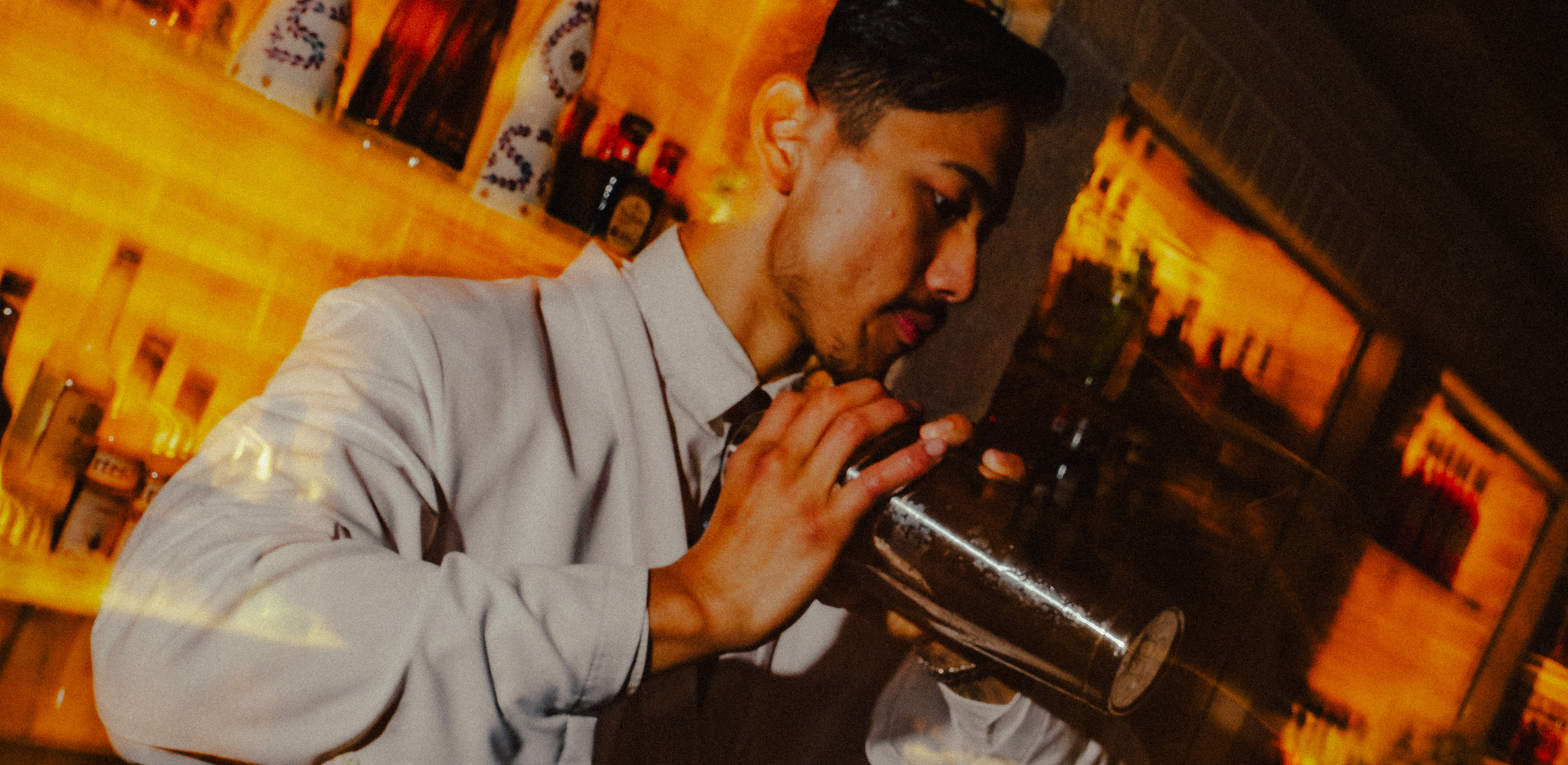 Image of a bartender shaking up a signature cocktail on the Rooftop bar at Jacksons on George.